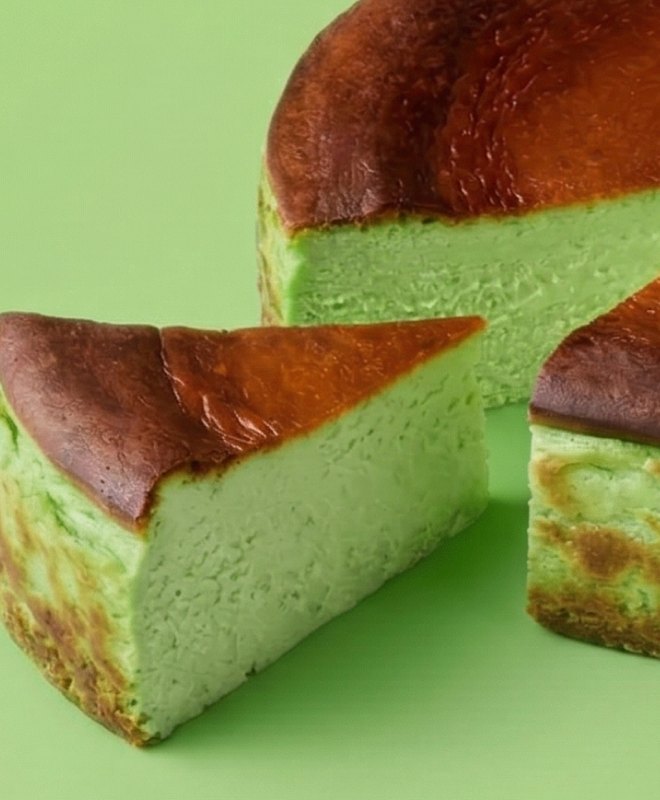 A slice of green pandan Basque cheesecake with a burnt caramel top